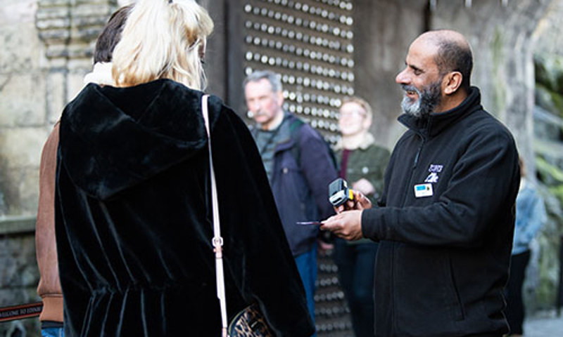 Admissions Assistant, Sherif Mehareb, checking tickets at the entrance to Edinburgh Castle